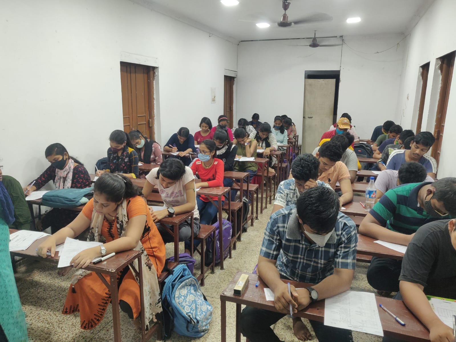 Students writing test in classroom