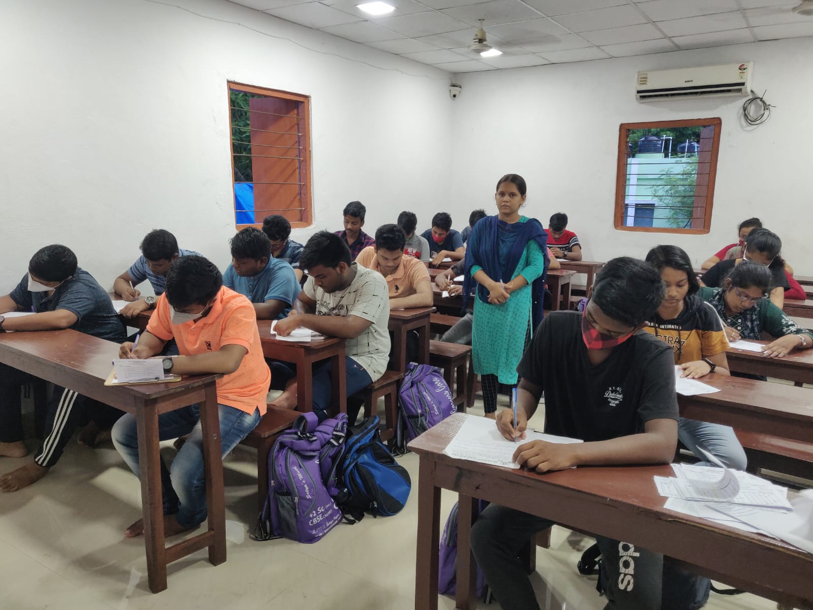 Teacher supervising students in exam hall