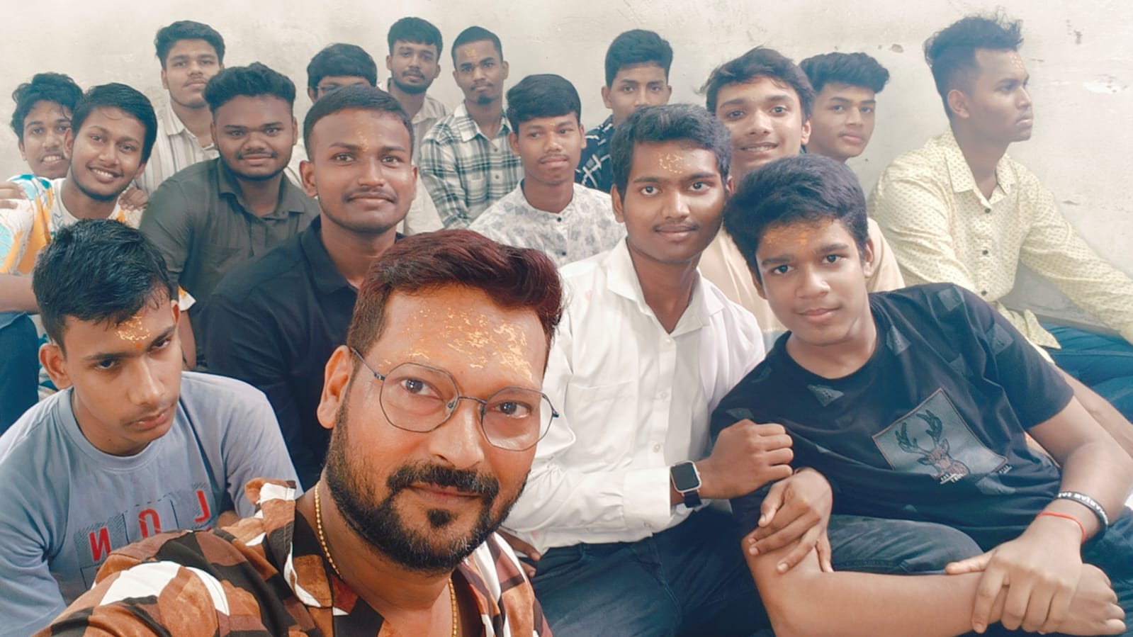 Selfie of teacher and students wearing tilak during Ganesh Puja celebrations