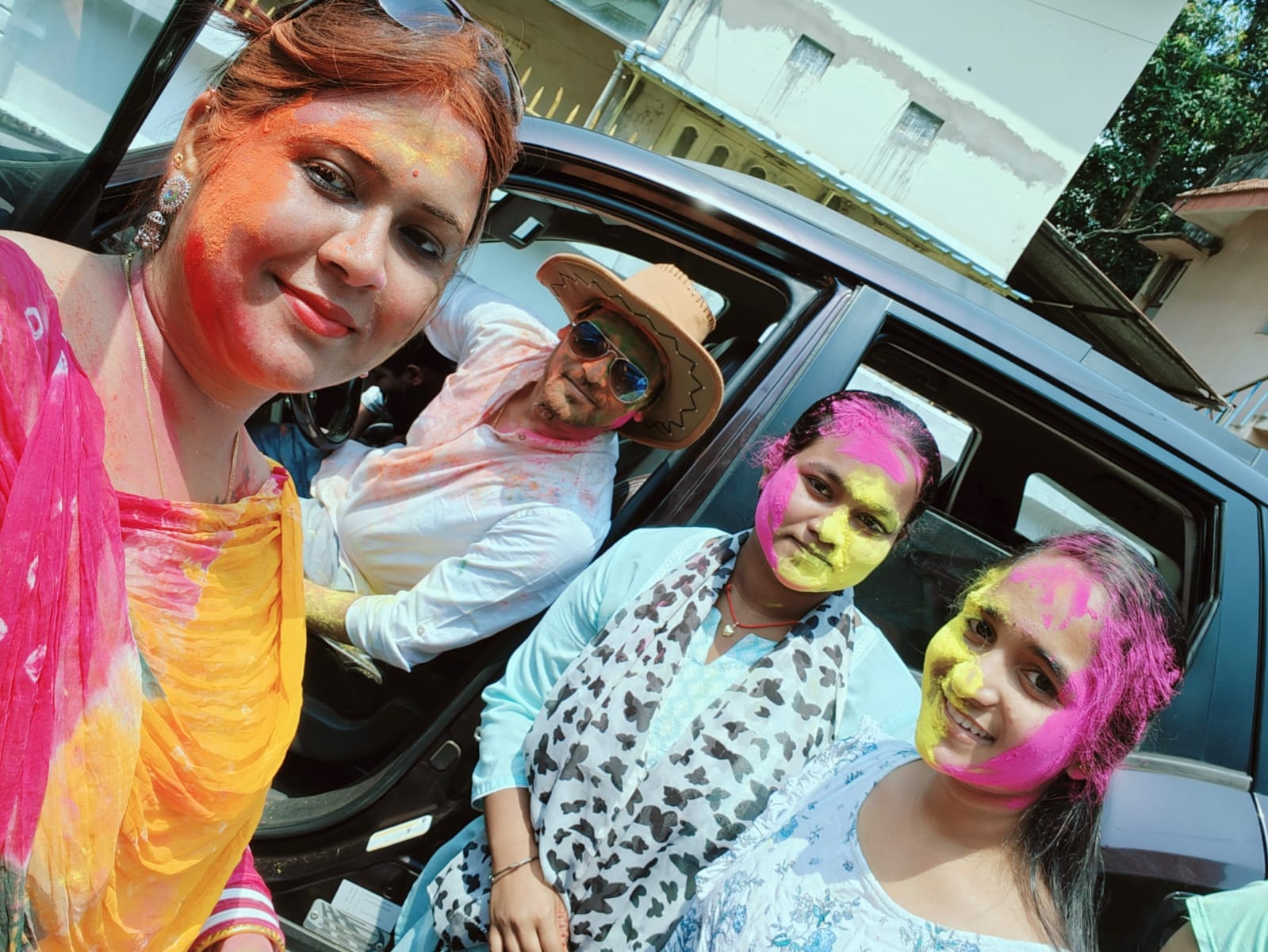 Director and students celebrating Holi with colours