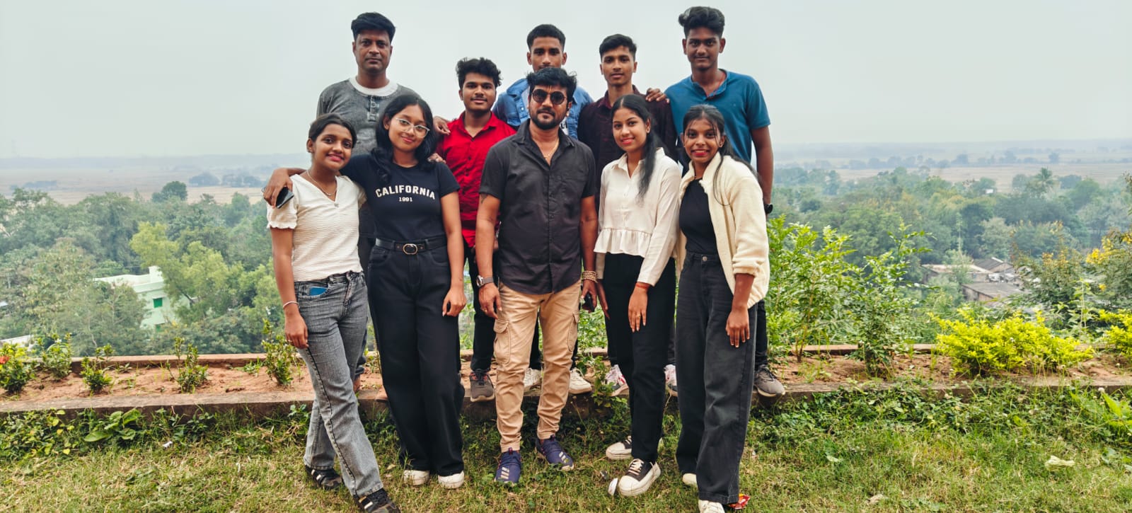 SS Career Care students and director posing on a beautiful hilltop during picnic outing