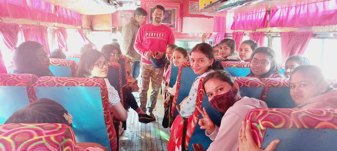 Excited students and faculty celebrating inside the picnic travel bus